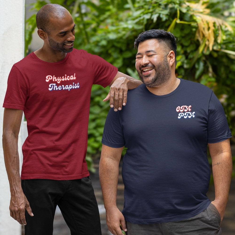 Two men standing outdoors, one wearing a red 'Physical Therapist' shirt and the other in a navy blue shirt with text.